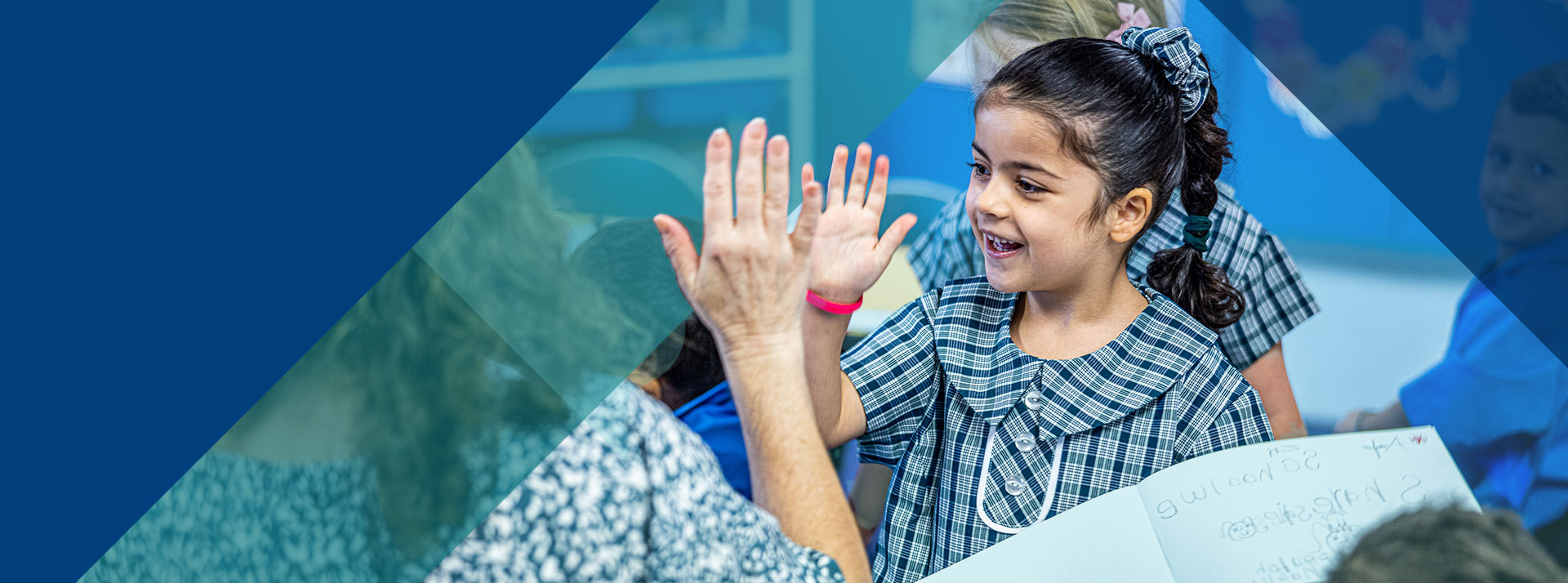 Student giving her teacher a high five in the classroom at Our Lady of Lourdes Primary School Baulkham Hills South