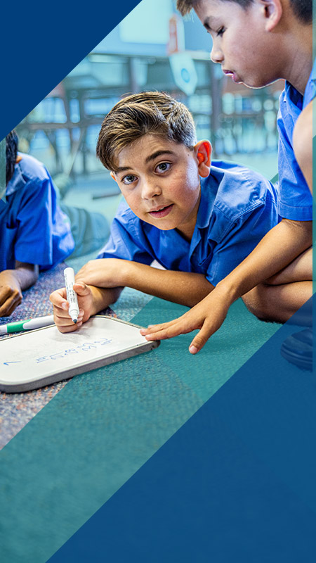Student writing in the classroom at Our Lady of Lourdes Primary School Baulkham Hills South