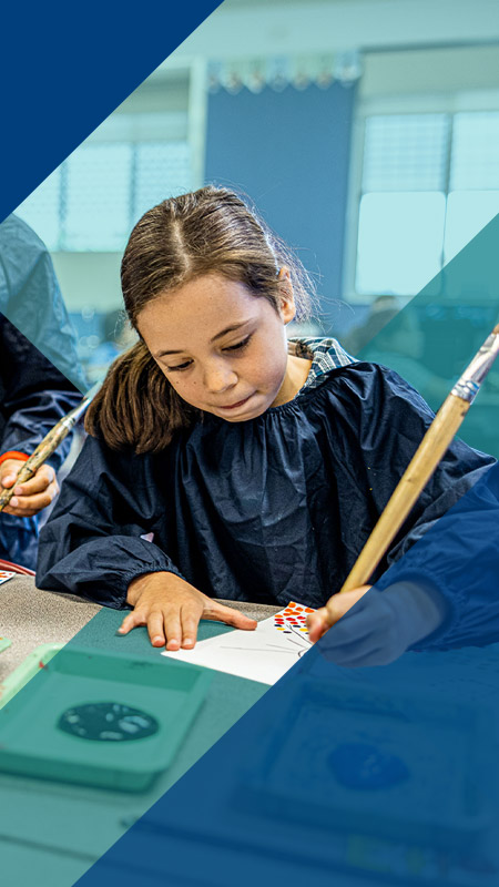 Student painting in the classroom at Our Lady of Lourdes Primary School Baulkham Hills South