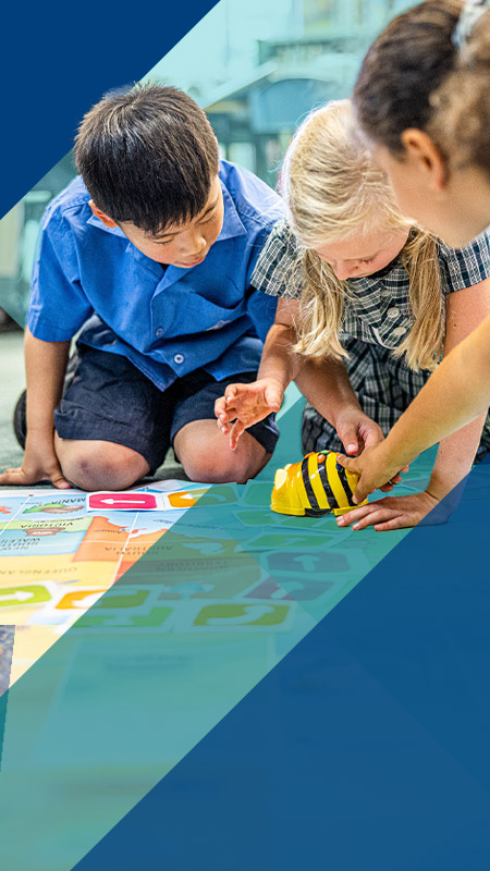 Students programming bee bots in the classroom at Our Lady of Lourdes Primary School Baulkham Hills South