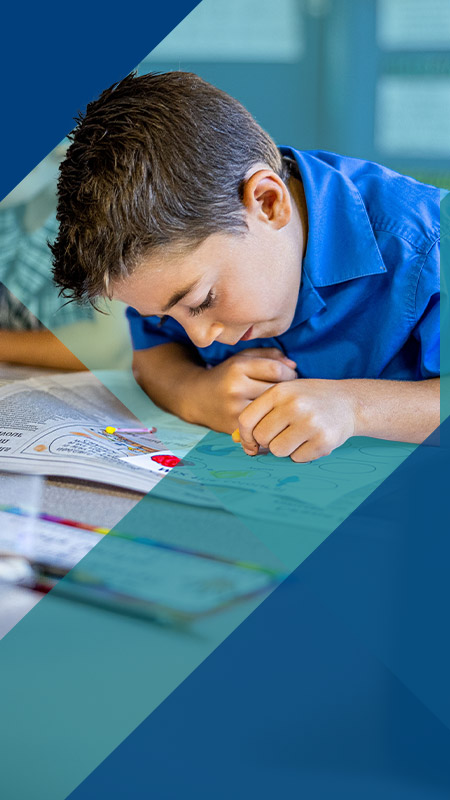 Student painting in the classroom at Our Lady of Lourdes Primary School Baulkham Hills South