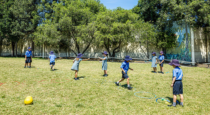 Students playing on the school oval at Our Lady of Lourdes Primary School Baulkham Hills South