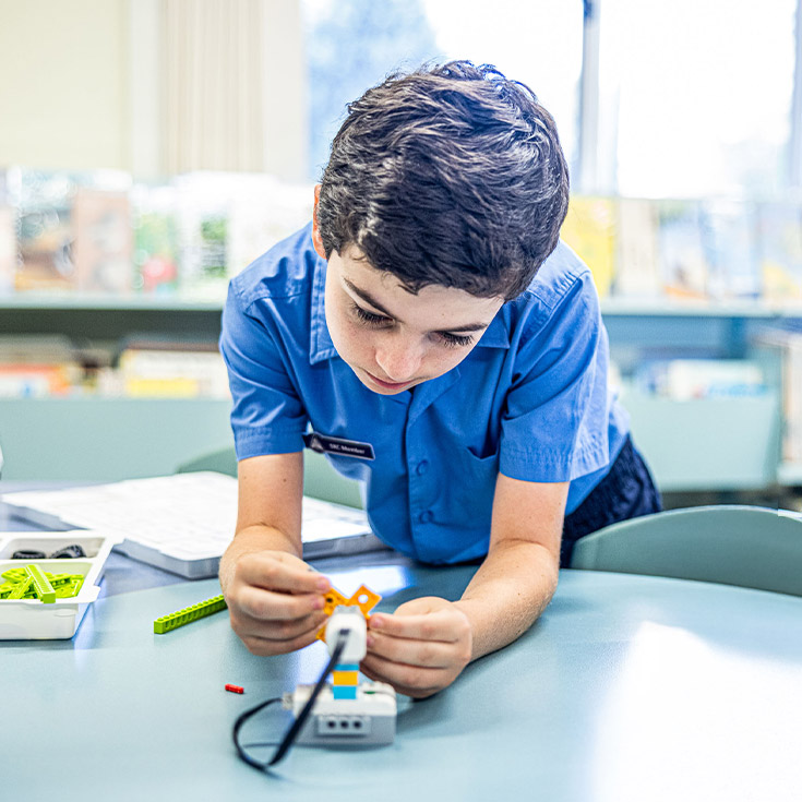 Student building a robot in the classroom at Our Lady of Lourdes Primary School Baulkham Hills South